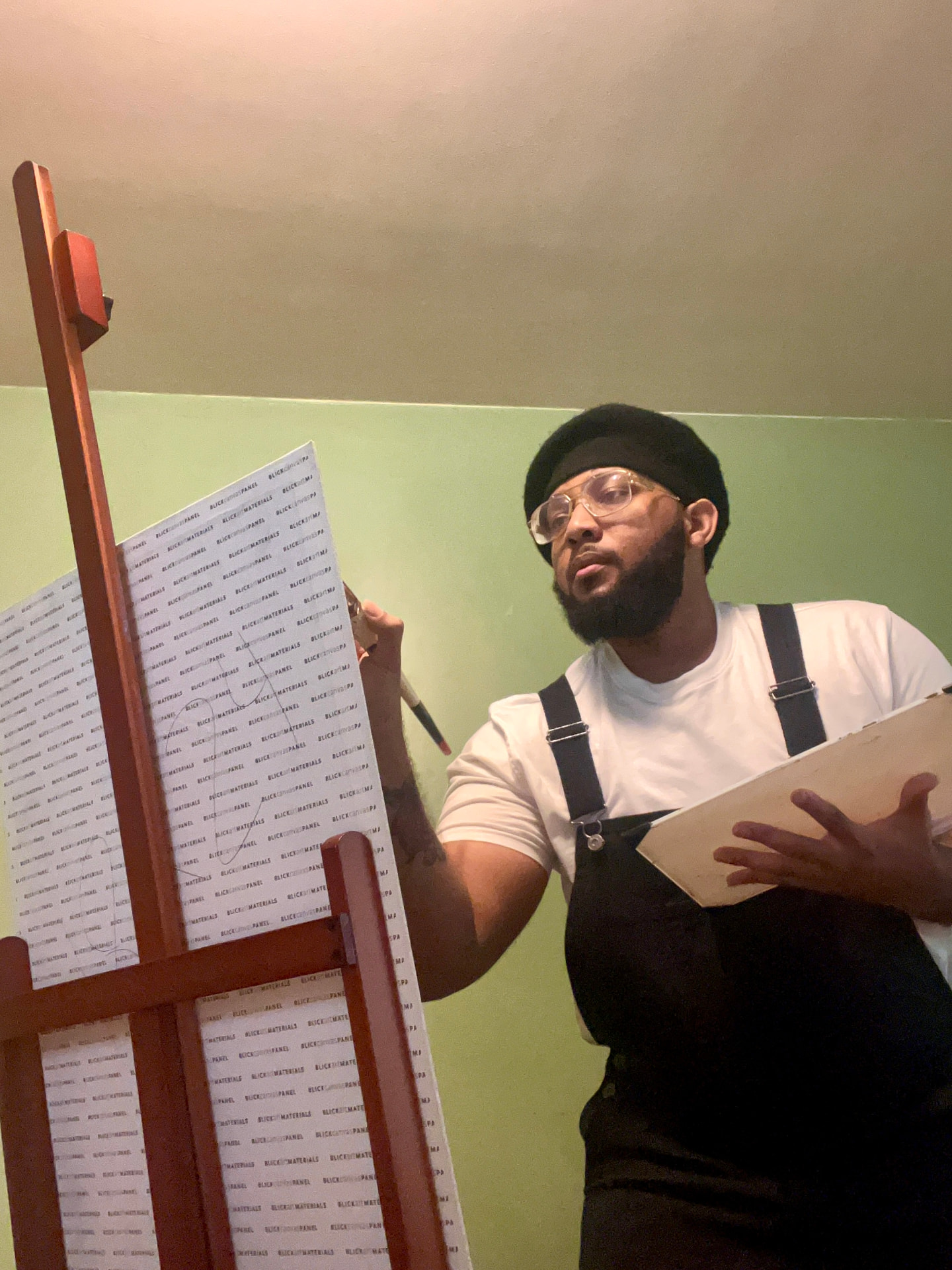 Jayfinity, artist and graphic designer, painting at an easel